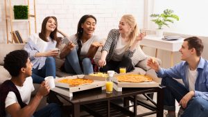 5 students enjoying a pizza party